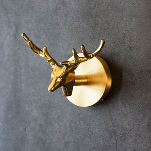 Wandhakenleiste aus Messing mit Tiermotiven und goldenen Akzenten